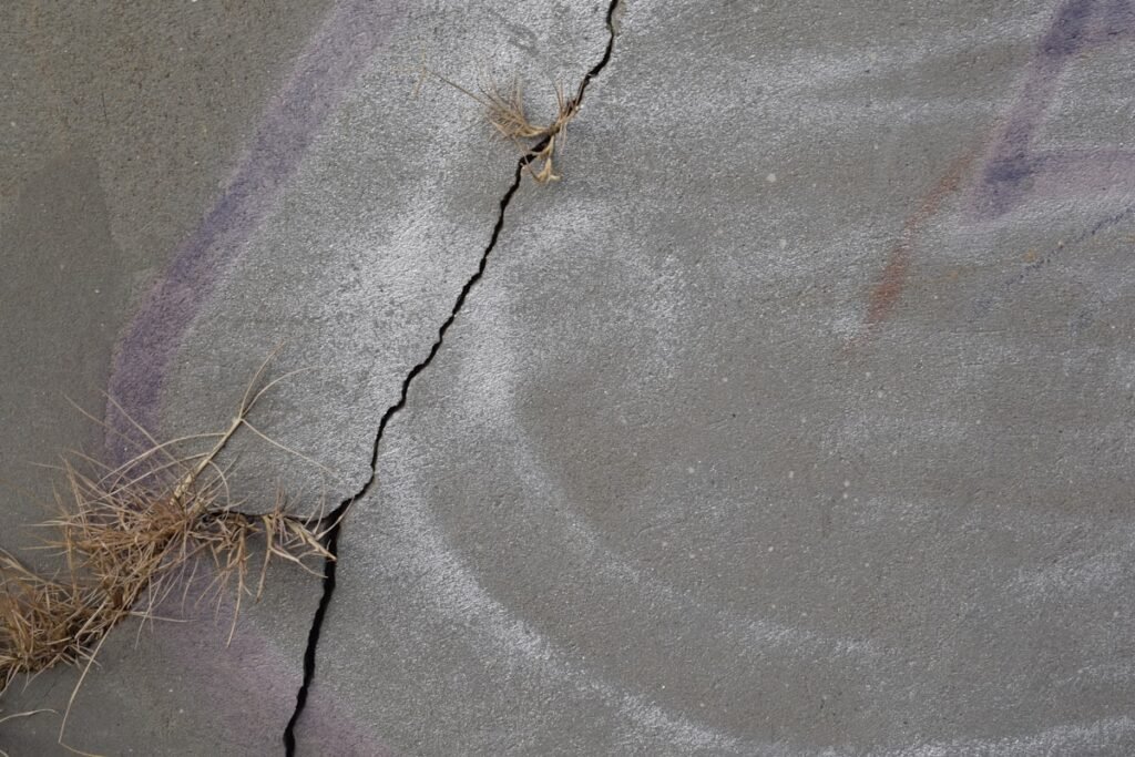 Cracked concrete slab showing signs that could indicate a slab leak under a Spring TX home